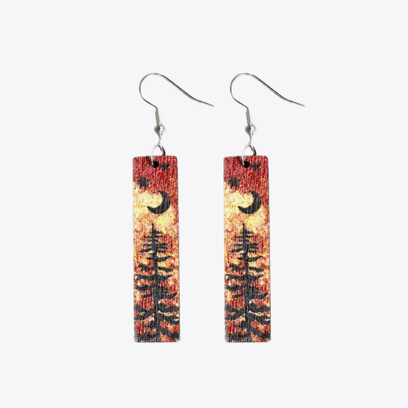 Stars and moon dangle earrings on wood