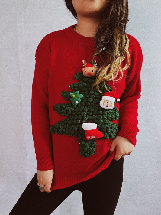 A woman is wearing a red sweater, capturing a festive vibe. The setting includes a Christmas tree, emphasizing a holiday theme. The outfit showcases seasonal fashion in vibrant red tones.