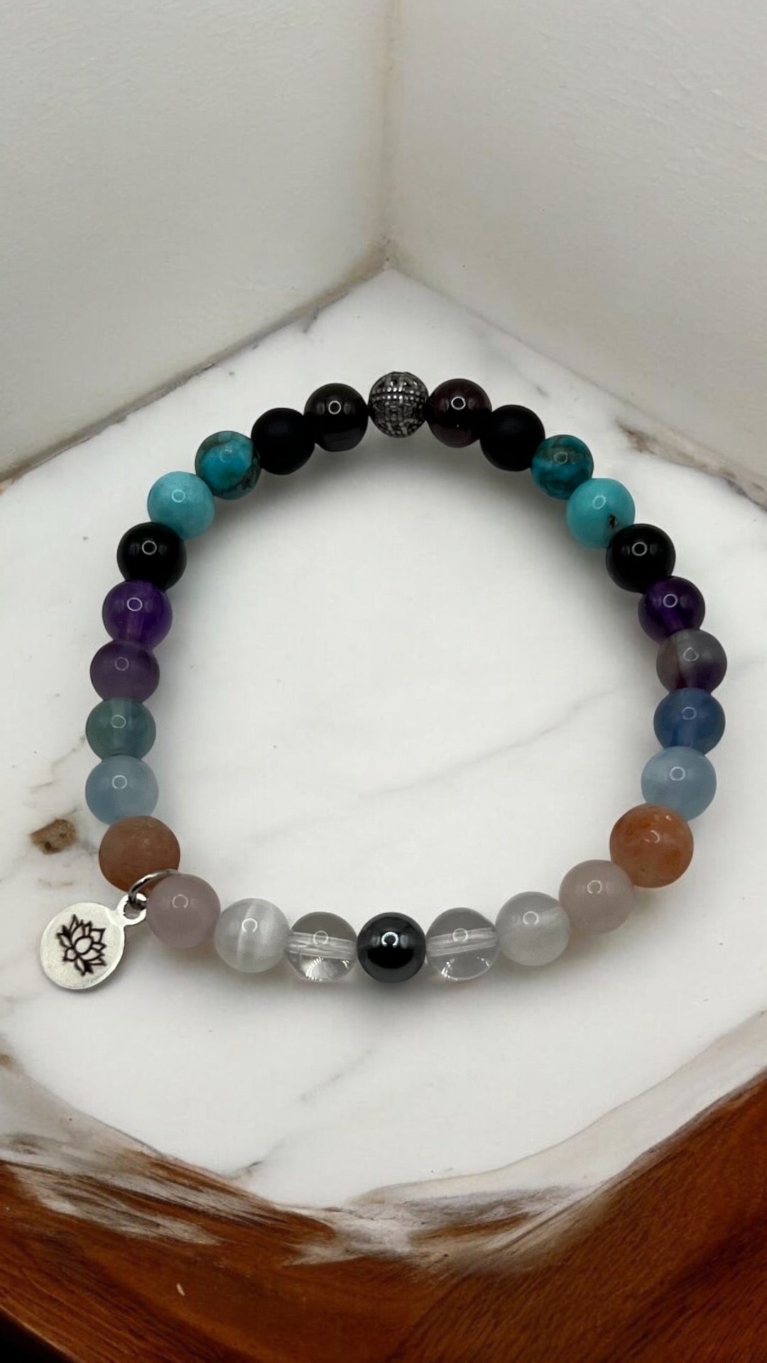 Bracelet with hematite, clear quartz, moonstone, rose quartz, sunstone, rainbow fluorite, aquamarine, amethyst, black tourmaline, turquoise, onyx, garnet, and delicate filigree details