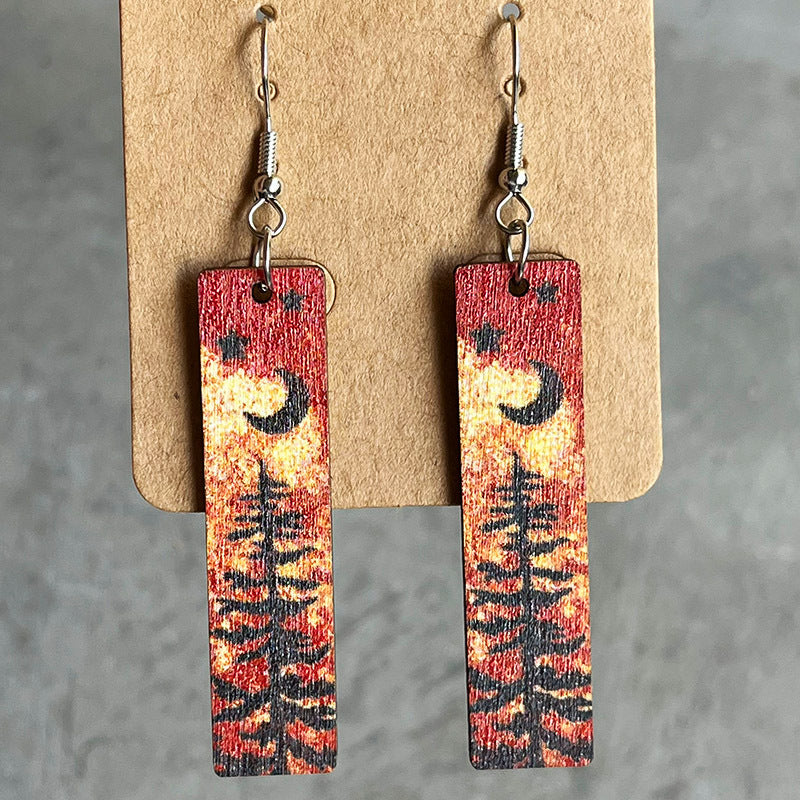 Stars and moon dangle earrings on wood