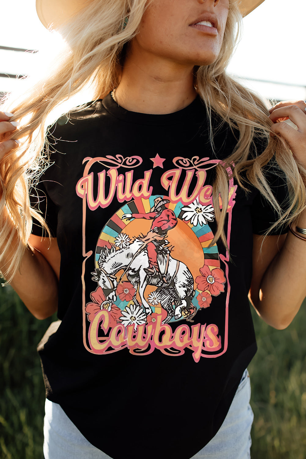 Black shirt with Wild West cowboys writing and picture of cowboy on bucking horse