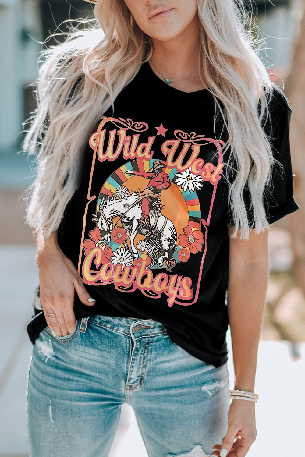 Black shirt with Wild West cowboys writing and picture of cowboy on bucking horse