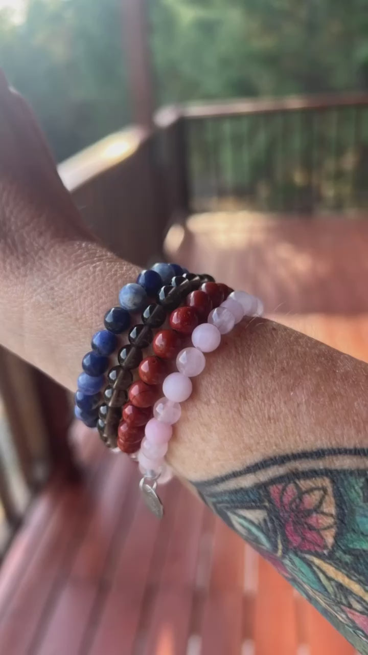 Scorpio stack crystal bracelet featuring rose, quartz, smoky quartz, red Jasper, and sodalite 