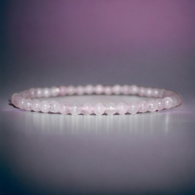 6mm Rose Quartz bracelet that represents unconditional love. Rose Quartz is a crystal that addresses feelings of love, compassion, and kindness. These stones are commonly used as aids in fixing relationship problems and promoting understanding. Rose Quartz also boosts feelings of peace, calm, and self-love.